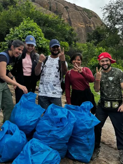 A team of eco-warriors with the results of their clean-up drive at Uttari Betta. We partner with companies to create impactful CSR trekking events.