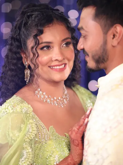 A beautiful Carnival look for a curly-haired bride. We embraced her natural texture with a half-up hairstyle and created a fresh, glowing makeup look to match her vibrant lime green lehenga.