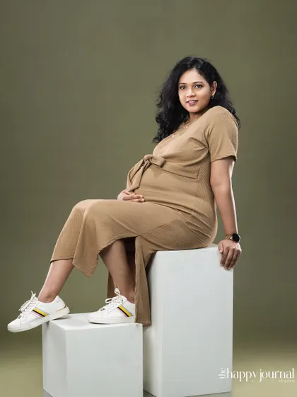 A cool and casual maternity look. Pairing a comfortable dress with sneakers shows that maternity photos can reflect your personal, everyday style.