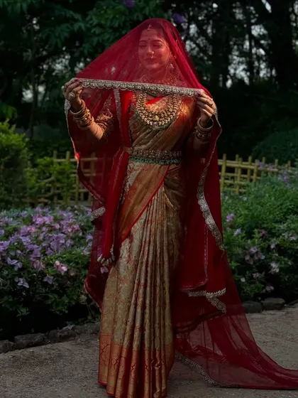 A full-length shot of the bride with her veil. The drape is structured to create a royal and commanding presence.