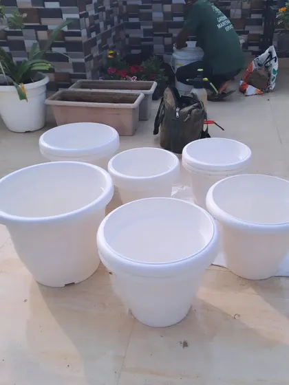 A collection of new, empty planters ready for a terrace gardening project. We help you select the right size, material, and style of pots to match your design vision and budget.