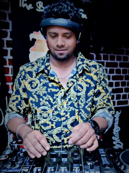 On deck duty, spinning tracks against a classic brick wall backdrop. I can adapt my setup and style to any club's aesthetic.