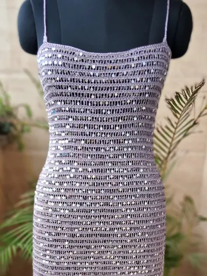 This handmade crochet cocktail dress, intricately woven with shimmering sequins, represents our vision of blending timeless craft with contemporary glamour. It's a statement piece designed to make you shine at any special occasion.