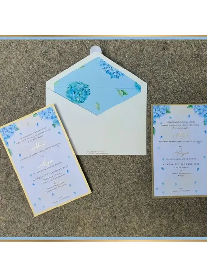 The full suite with the powder blue hydrangeas, including an envelope with a matching floral liner.