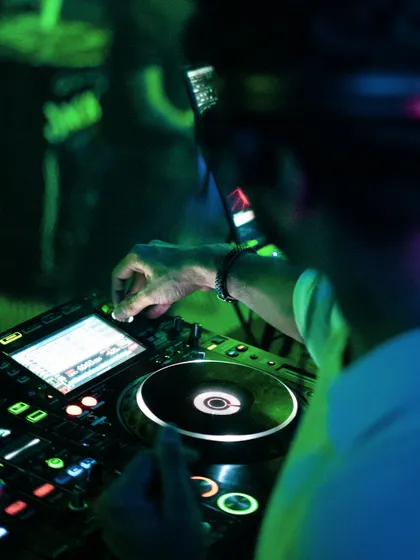 A close-up on my hands working the mixer at Club Illusions. This shot gives a glimpse into the technical skill and precision behind a live DJ set.