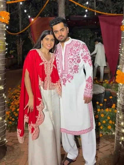 A client in a custom white kurta with pink embroidery, inspired by a popular celebrity look.