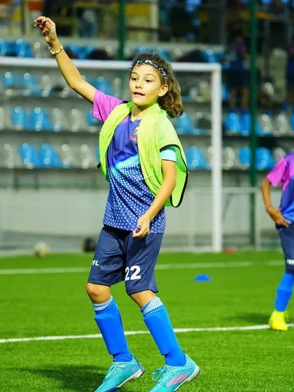 A young female player participates in a throwing drill, showcasing her skills in our inclusive training environment.