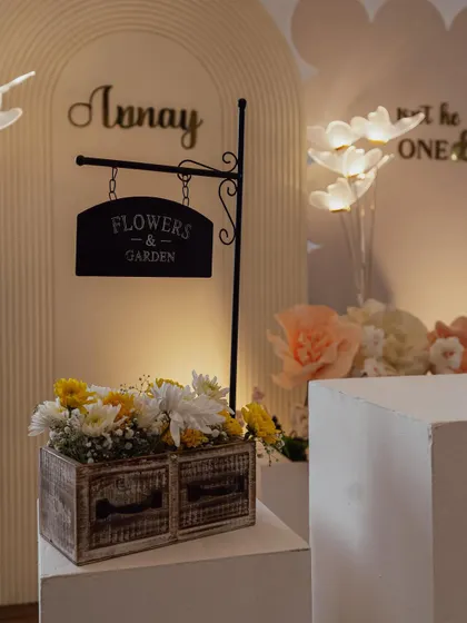 It's all in the details. A rustic wooden flower box with a charming "Flowers & Garden" sign, adding an authentic touch to a garden-themed birthday party.