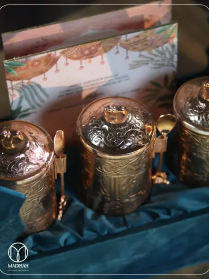 A close-up of the intricately designed mukhwaas jars. The detailed patterns and matching spoons reflect a commitment to craftsmanship and a love for the little things.