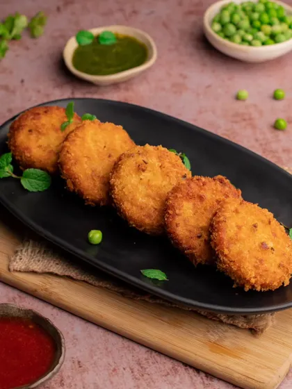 Another look at our vegetable patties, this time on a sleek black plate. This composition gives the simple snack a more modern and refined look.
