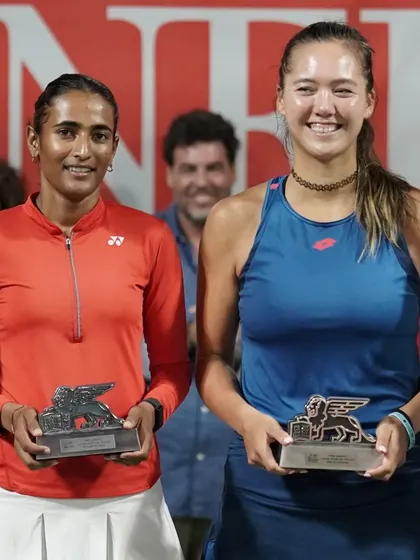 A close-up of our doubles finalists, Rutuja Bhosale and Sophie Chang, holding their trophies at the ITF W50 in Spain.