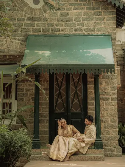 A quiet, shared moment on the steps of a rustic stone building. This image captures the peaceful beginning of their forever, away from the day's festivities.