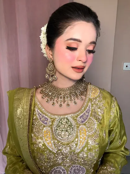 Eyes closed, this shot highlights the soft, peachy eyeshadow and perfectly winged liner.