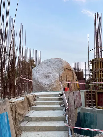 The entrance steps of the Lurra House materializing on site, leading up to the central boulder. This image captures the moment a design concept begins to become a physical reality.