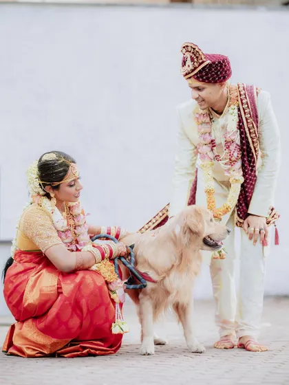 The couple sharing a moment with their furry family member. Including pets in wedding photos adds a personal and heartwarming touch to the album.