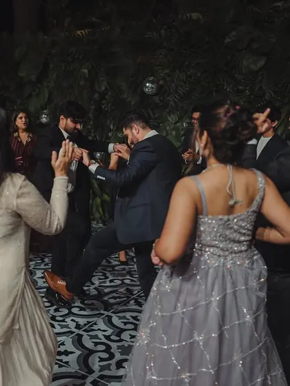 Guests letting loose on the dance floor during a lively cocktail party. I ensure the music, lighting, and atmosphere are perfect for a night of non-stop dancing.