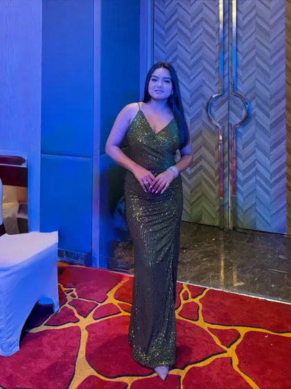 A full-length shot of the olive green sequin dress, perfect for a glamorous night out.