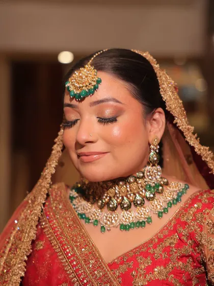 A full bridal look featuring a red lehenga with green-accented kundan jewellery. These images show how you can create a perfectly coordinated and stunning bridal look through my rental service.