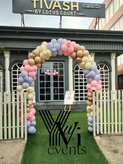 A beautiful pastel balloon arch at the entrance of a venue for a baby shower, creating a welcoming sight for guests.