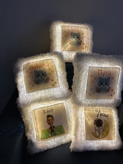 A collection of personalized LED cushions I made for a bulk order, featuring cute characters, caricatures, and names.