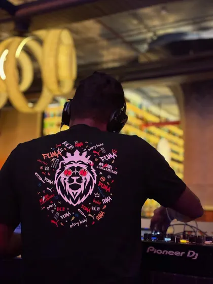 Another angle of me at work on the Pioneer DJ setup. Quality equipment is non-negotiable for me, as it ensures crystal clear sound and reliability for your entire event.