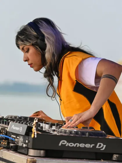 Locked in during a daytime set. The focus is always on reading the crowd and selecting the perfect next track.