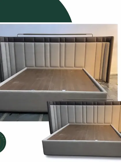 This bed features a tall, winged headboard with two-tone vertical paneling. The design creates a cozy, enclosed feeling while making a strong visual statement in the bedroom.