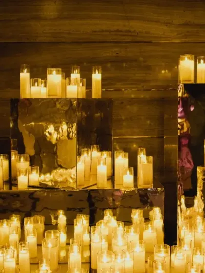 A sea of candles on mirrored surfaces creates an infinite, glowing landscape. This simple yet powerful concept was used to create a deeply romantic and mesmerizing atmosphere for the engagement.
