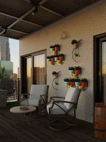 We created a rustic, countryside feel for this city balcony. The design includes rocking chairs, a wine barrel table, and colorful wall-mounted planters, all set on a dark wood deck to evoke a warm, traditional charm.
