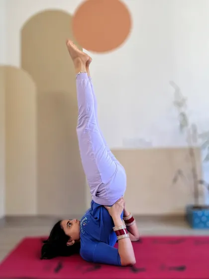 A supported shoulderstand, or Salamba Sarvangasana. This inversion is known as the "queen of all asanas" for its many benefits. Here, I'm using my hands to support my back to maintain proper alignment.
