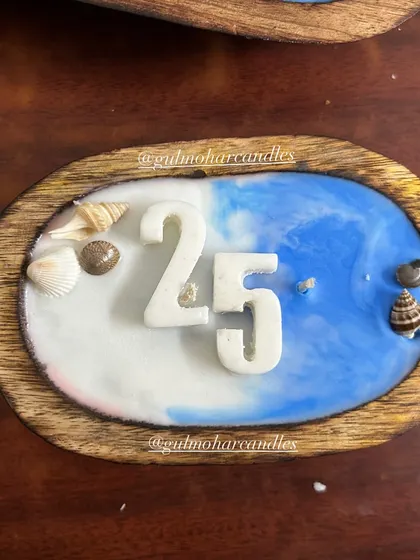 This beach-themed candle was customized for a 25th anniversary. I can add numbers or initials on top to make it a perfect gift for any milestone.