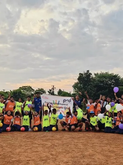 A large group of students and facilitators pose for a photo after the Children's Day celebrations. The event brought together 124 young participants for a memorable day of fun and games.