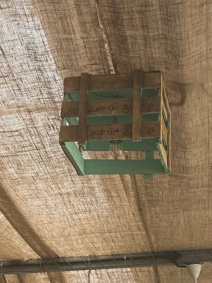 We believe in sustainability. This light fixture is made from a repurposed wooden crate, one of the many small details that contribute to our eco-friendly decor.