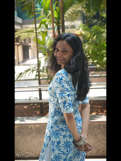A classic over-the-shoulder smile. This is a timeless portrait style that is always flattering and full of charm, perfect for personal photos.