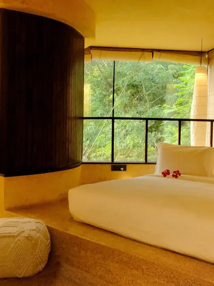A suite designed for ultimate relaxation, with a sunken bed and a curved wall that leads to the bathroom, creating a soft, flowing space.