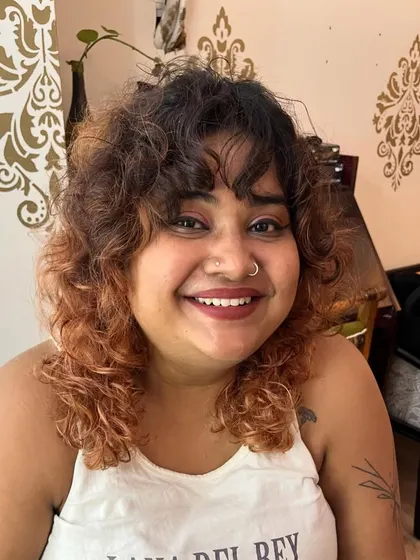 A fun curly shag for Chiru with a warm, coppery color melt.