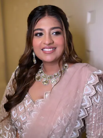 The final look is one of pure elegance. The soft makeup and wavy hair perfectly complement her sparkling pastel lehenga.