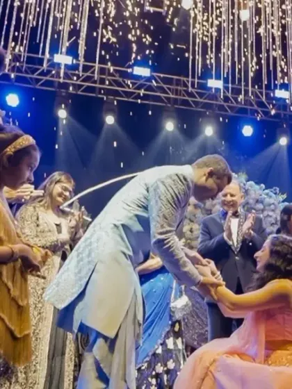 The couple's proposal moment on stage, complete with cold pyro effects for a touch of drama and celebration.