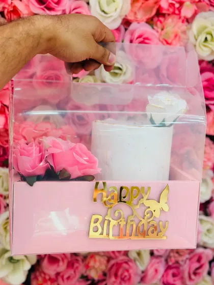 This is my signature birthday hamper, designed to make gifting simple and special. It features a half-kg tall cake, fresh flowers, and a golden 'Happy Birthday' topper, all beautifully packaged.