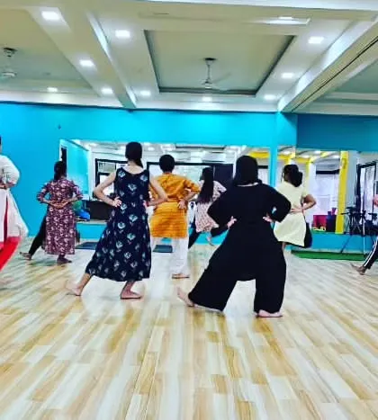 A view from the back of the class, showing the synchronized movements and focus of our adult Bharatanatyam students.