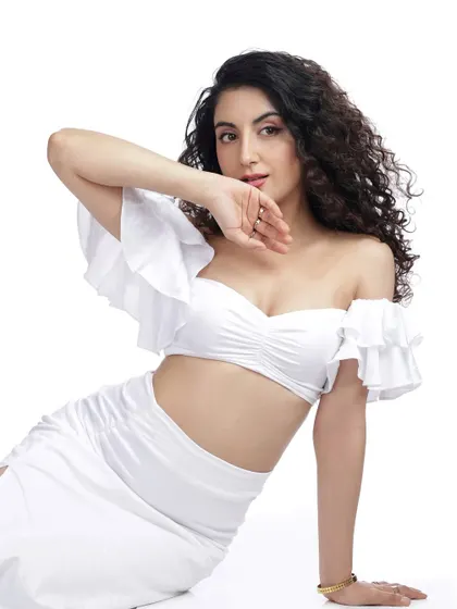 A playful and confident pose from the all-white studio session. This shot captures a moment of connection and personality, which is great for commercial work.