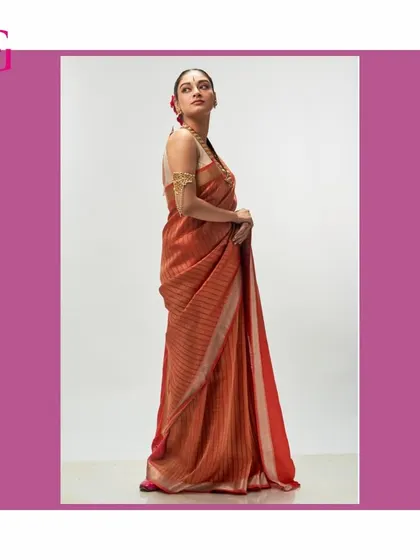 A side profile of the orange silk linen saree, highlighting its elegant silhouette and rich, warm hue.
