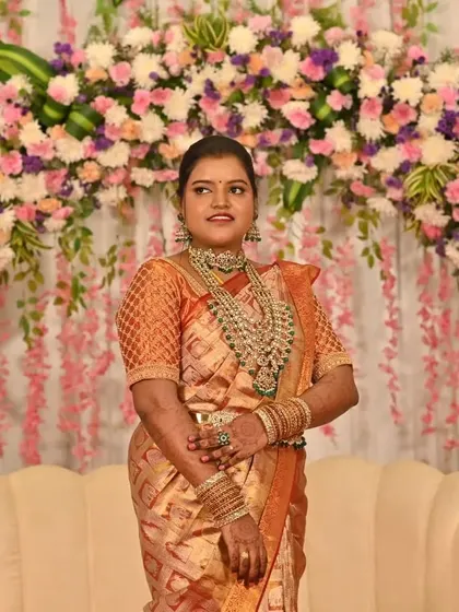 A full view of Sugandhi's reception elegance. The combination of the grand floral decor and her timeless look created a picture-perfect moment.