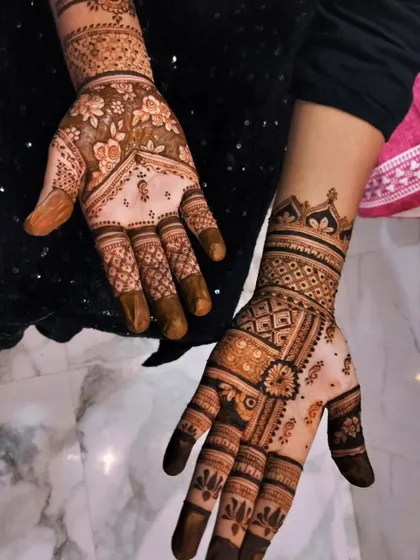 An elegant, mismatched design set. One hand features a floral pattern with negative space, while the other has a more geometric, filled-in look.