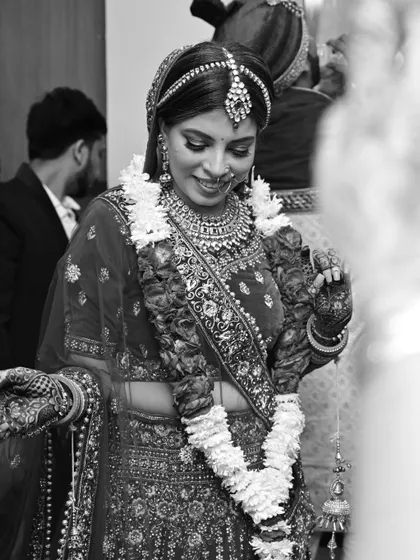 A classic black and white shot of the bride during the ceremony, her expression a mix of shyness and happiness.