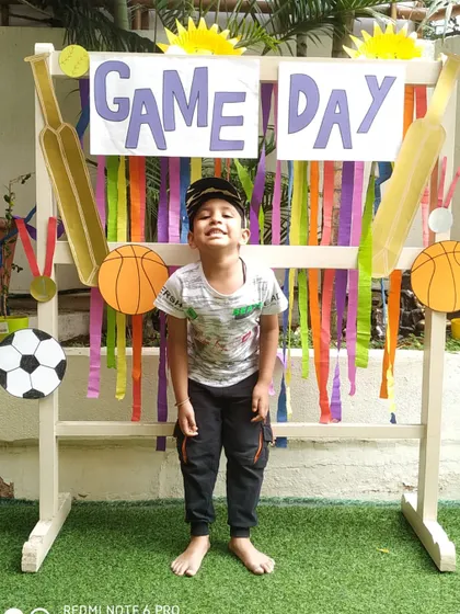 A big, cheesy grin from a camper at our "Game Day" photo booth. We make sure to celebrate every child's participation with fun photo opportunities.