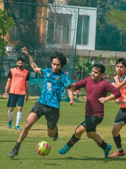 Intense midfield battle as players from different companies compete for bragging rights.