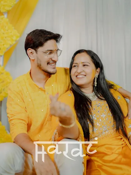 A lovely portrait of the couple with a "Haldi" text overlay, perfect for sharing as a summary of their beautiful day.