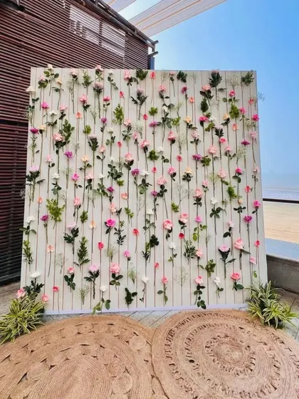 Sometimes, simplicity is the ultimate elegance. This beautiful floral photo wall was designed for a beachside event, with individual stems of pink and white roses creating a delicate and romantic backdrop against the ocean view.