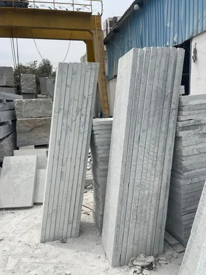 Long, machine-cut stone slabs stacked and ready for a project.